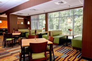 a restaurant with tables and chairs and windows at Fairfield Inn & Suites by Marriott Richmond Midlothian in Richmond