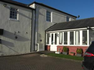 a white house with white windows and a driveway at Lynebank House Hotel, Bed & Breakfast in Carlisle