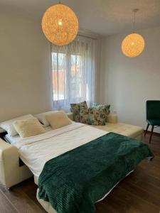 a bedroom with a large bed and two lights at Monako Luxury Apartment in Vrnjačka Banja