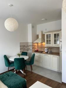 a kitchen with a table and chairs in a room at Monako Luxury Apartment in Vrnjačka Banja
