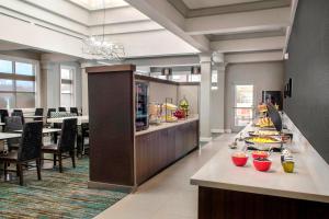 a restaurant with a buffet with food on a counter at Residence Inn by Marriott Newark Elizabeth/Liberty International Airport in Elizabeth