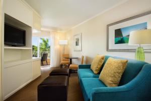 a living room with a blue couch and a tv at Fairfield Inn & Suites by Marriott Key West in Key West
