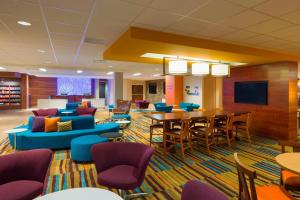 a waiting room with a table and chairs at Fairfield Inn & Suites by Marriott Paramus in Paramus