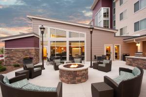 a patio with chairs and a fire pit in front of a building at Residence Inn by Marriott Bloomington in Bloomington