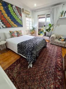 a bedroom with a bed with a leopard print blanket at Vista unit Close to the City & Airport & Train station and Brighton Le Sands Beach in Sydney