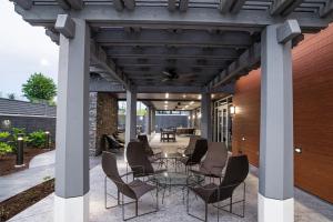 an outdoor patio with a glass table and chairs at Courtyard by Marriott Greenville Mauldin in Greenville