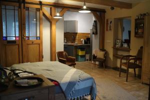 a bedroom with a bed and a kitchen with chairs at Urlaub im Friseursalon in Sebnitz