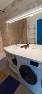 a bathroom with a sink and a mirror at MIREILLE - Appartement 4 etoiles vue mer - 2 a 4 pers in Les Sables-dʼOlonne