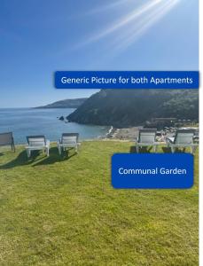 a picture of a beach with chairs on the grass at Ocean View Apartments in Looe