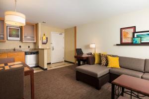 a living room with a couch and a kitchen at Residence Inn Dayton North in Dayton