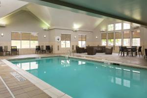 a pool with chairs and tables in a hotel at Residence Inn Dayton North in Dayton