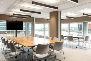 a conference room with a large wooden table and chairs at AC Hotel by Marriott Belfast in Belfast