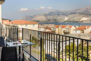 a balcony with a table and a view of a city at Anthemis Living in Argostoli