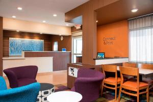 a waiting room with purple chairs and a counter at Fairfield Inn & Suites Mt. Pleasant in Mount Pleasant