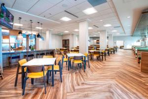 a dining area with tables and chairs in a restaurant at Fairfield Inn & Suites by Marriott Ottawa Airport in Ottawa