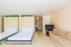a living room with a bed and a couch at Ilikai Marina 985 in Honolulu