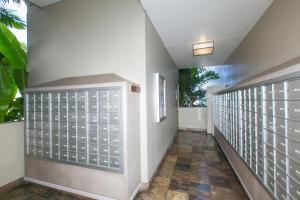 a hallway of a house with white walls and a tile floor at Ilikai Marina 985 in Honolulu