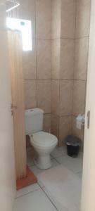 a bathroom with a white toilet in a room at Jardim Urbano Cambará do Sul in Cambara do Sul