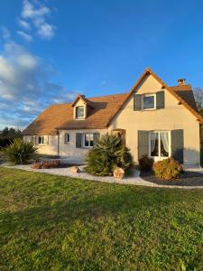 a house with a landscaping in front of a yard at Le Repaire des Bolides - 24H du Mans - 6p - Wi-Fi 