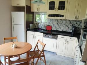a kitchen with a table and a white refrigerator at Rada Home in Marmaris