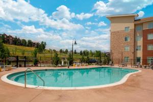 a large swimming pool in front of a building at Fairfield Inn & Suites by Marriott Boulder Broomfield/Interlocken in Broomfield