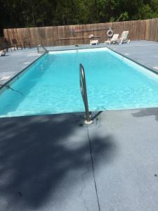 a swimming pool with a metal pole in the middle at Orange Beach! Spacious mobile home near the beach! in Orange Beach