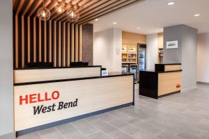 a store with a hello west bend sign in a lobby at TownePlace Suites By Marriott Milwaukee West Bend in West Bend