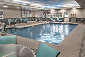 a large swimming pool with chairs and tables at Residence Inn Pittsburgh Cranberry Township in Cranberry Township
