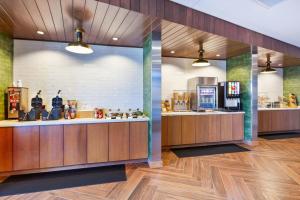 a lobby with a food counter and a kitchen at Fairfield Inn & Suites by Marriott Cincinnati Airport South/Florence in Florence