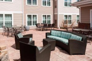 a patio with wicker chairs and tables and a couch at Residence Inn Manassas Battlefield Park in Manassas