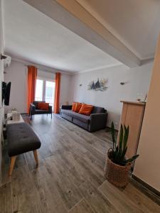 a living room with a couch and a table at Casa Pescador in Carvoeiro