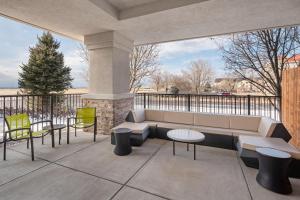 a patio with a couch and tables and chairs at SpringHill Suites by Marriott Denver Airport in Denver