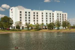 a person in a duck in the water in front of a building at SpringHill Suites Orlando Airport in Orlando
