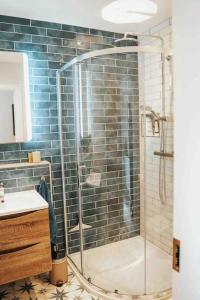 a bathroom with a shower with a glass door at The Sea Loft Castlerock. in Castlerock