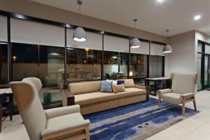 a living room with a couch and two chairs at TownePlace Suites by Marriott San Diego Central in San Diego