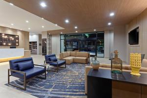 a lobby with blue chairs and a living room at TownePlace Suites by Marriott San Diego Central in San Diego