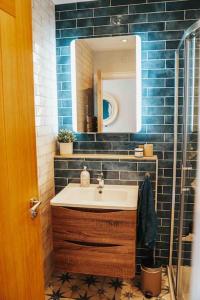 a bathroom with a sink and a mirror at The Sea Loft Castlerock. in Castlerock