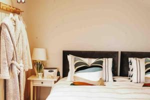 a bedroom with a bed with a black headboard and pillows at The Sea Loft Castlerock. in Castlerock