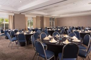 a conference room with tables and chairs in a room at SpringHill Suites Orlando Airport in Orlando