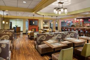 a restaurant with couches and tables and a bar at DoubleTree by Hilton Minneapolis Airport, MN in Bloomington