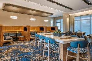 a lobby with a bar with blue chairs at Courtyard by Marriott Fort Lauderdale Downtown in Fort Lauderdale