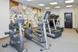 a gym with several tread machines in a room at SpringHill Suites by Marriott Lancaster Palmdale in Lancaster