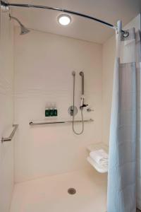 a bathroom with a shower with a shower curtain at Residence Inn by Marriott St. Paul Downtown in Saint Paul