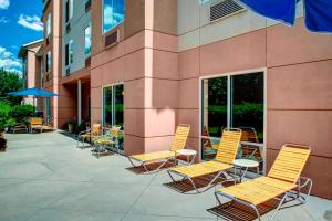 un grupo de sillas y mesas fuera de un edificio en Fairfield Inn and Suites by Marriott Emporia I-95, en Emporia