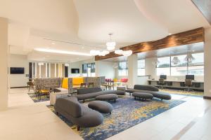 a lobby with chairs and tables and a waiting room at SpringHill Suites by Marriott Fort Worth Fossil Creek in Fort Worth