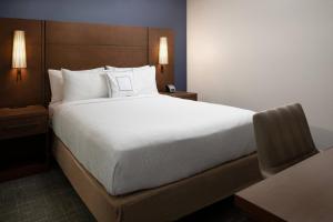 a bedroom with a large bed with white sheets and pillows at Residence Inn by Marriott Las Vegas Convention Center in Las Vegas