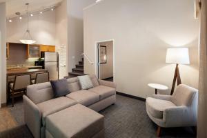 a living room with a couch and chairs and a kitchen at Residence Inn by Marriott Las Vegas Convention Center in Las Vegas