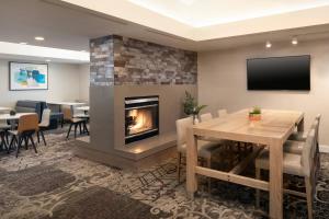 a dining room with a fireplace and a table and chairs at Residence Inn by Marriott Las Vegas Convention Center in Las Vegas