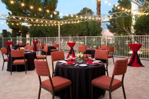 a set of tables and chairs in a patio with lights at Residence Inn by Marriott Las Vegas Convention Center in Las Vegas
