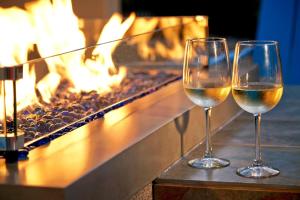 two glasses of white wine next to a fireplace at Residence Inn by Marriott Naples in Naples